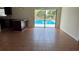 Open-concept living room with tile flooring leading to a sliding glass door and pool view at 1592 Martin Luther King Ne Blvd, Winter Haven, FL 33881