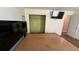 This main bedroom features hardwood floors, closet space, and a TV for modern convenience at 1592 Martin Luther King Ne Blvd, Winter Haven, FL 33881