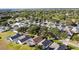 An aerial view of the neighborhood with manicured lawns, mature trees, and community features at 1717 Clubhouse Cv, Haines City, FL 33844