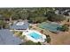 An aerial view featuring the community pool, tennis courts, and manicured landscaping at 1717 Clubhouse Cv, Haines City, FL 33844