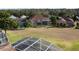 Aerial view showcasing a home with a pool and screened enclosure at 1717 Clubhouse Cv, Haines City, FL 33844