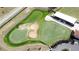 Aerial view of putting green with sand traps and clubhouse at 1717 Clubhouse Cv, Haines City, FL 33844