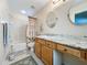 Bathroom with a shower, bathtub, vanity with double mirrors, and neutral wall color at 1717 Clubhouse Cv, Haines City, FL 33844