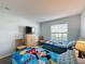 Bedroom featuring two beds, dresser, and window with blinds at 1717 Clubhouse Cv, Haines City, FL 33844