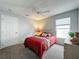 Carpeted bedroom with plush bed, window, closet, and side table at 1717 Clubhouse Cv, Haines City, FL 33844