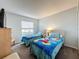 Bedroom featuring two beds, dresser, and window with blinds at 1717 Clubhouse Cv, Haines City, FL 33844