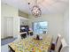 Dining area features modern light fixture and sliding doors to outdoor patio at 1717 Clubhouse Cv, Haines City, FL 33844