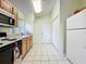 Traditional kitchen featuring neutral cabinets and tile flooring at 1717 Clubhouse Cv, Haines City, FL 33844