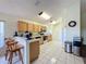 Functional kitchen featuring breakfast bar, appliances, and convenient access to dining area at 1717 Clubhouse Cv, Haines City, FL 33844