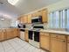 Bright kitchen with wooden cabinets, stone countertops, and stainless steel appliances, perfect for cooking and entertaining at 1717 Clubhouse Cv, Haines City, FL 33844