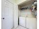 Efficient laundry room with washer, dryer, shelving, and closet for all your household needs at 1717 Clubhouse Cv, Haines City, FL 33844