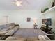Cozy living room with neutral carpet, ceiling fan, and entertainment center at 1717 Clubhouse Cv, Haines City, FL 33844