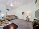 Bright living room with vaulted ceiling, neutral carpet, and comfortable seating at 1717 Clubhouse Cv, Haines City, FL 33844
