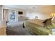 Spacious carpeted main bedroom features a patio door with an outdoor seating area at 1717 Clubhouse Cv, Haines City, FL 33844