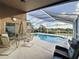 Covered patio features a screened-in pool, comfortable seating, and ample space for outdoor dining and relaxation at 1717 Clubhouse Cv, Haines City, FL 33844