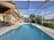 The pool is screened-in and is connected to an outdoor seating area for relaxation and entertainment at 1717 Clubhouse Cv, Haines City, FL 33844