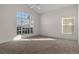 Main bedroom with large window and carpet at 1739 Morning Star Dr, Clermont, FL 34714
