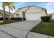 One-story house with a two-car garage and palm trees at 1739 Morning Star Dr, Clermont, FL 34714