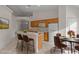 Eat-in kitchen with light wood cabinets and a breakfast bar at 1739 Morning Star Dr, Clermont, FL 34714
