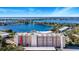 Aerial view of lakefront condo building with pool and tennis courts at 1776 6Th St Nw # 209, Winter Haven, FL 33881