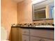 Bathroom features granite countertop, updated cabinets, and tile at 1776 6Th St Nw # 209, Winter Haven, FL 33881