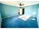 Bright bedroom with blue carpet and ceiling fan at 1776 6Th St Nw # 209, Winter Haven, FL 33881