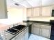 Kitchen with granite countertops and light cabinets at 1776 6Th St Nw # 209, Winter Haven, FL 33881