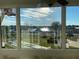 View of lake from sunroom with multiple windows at 1776 6Th St Nw # 209, Winter Haven, FL 33881