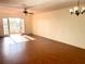 Spacious living room with hardwood floors and access to balcony at 1776 6Th St Nw # 209, Winter Haven, FL 33881