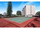 Community tennis court with a red surface at 1776 6Th St Nw # 209, Winter Haven, FL 33881