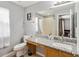Bathroom with granite vanity, toilet, and large mirror at 2143 Calabria Ave, Davenport, FL 33897