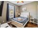 Cozy bedroom with a white bed frame and wood flooring at 2143 Calabria Ave, Davenport, FL 33897