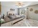Spacious primary bedroom with large window and plush bedding at 2143 Calabria Ave, Davenport, FL 33897