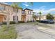 Two-story townhome with attractive landscaping and a paved driveway at 2143 Calabria Ave, Davenport, FL 33897