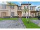 Two-story townhome with attractive landscaping and a paved driveway at 2143 Calabria Ave, Davenport, FL 33897