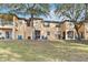 Townhouse exterior with grassy backyard and trees at 2143 Calabria Ave, Davenport, FL 33897