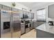 Modern kitchen with gray cabinets, granite countertops, and stainless steel appliances at 2143 Calabria Ave, Davenport, FL 33897