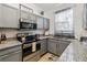 Modern kitchen featuring stainless steel appliances and granite countertops at 2143 Calabria Ave, Davenport, FL 33897