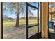 Screened porch with view of grassy backyard and trees at 2143 Calabria Ave, Davenport, FL 33897