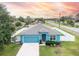 Single story home, blue exterior, white fence, and driveway at 233 Tiffany Ct, Kissimmee, FL 34758