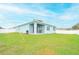 Newly built home with a spacious backyard, covered patio, and white vinyl fence at 233 Tiffany Ct, Kissimmee, FL 34758