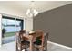 Dining area with a square wooden table and six brown leather chairs at 233 Tiffany Ct, Kissimmee, FL 34758