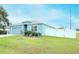 Light blue single-Gathering home with a two-car garage and a well-maintained lawn at 233 Tiffany Ct, Kissimmee, FL 34758