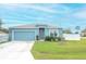One-story house with blue exterior, two-car garage, and landscaped yard at 233 Tiffany Ct, Kissimmee, FL 34758