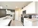 Modern kitchen with white cabinets, stainless steel appliances, and an island at 233 Tiffany Ct, Kissimmee, FL 34758