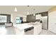 Modern kitchen with white cabinets, stainless steel appliances, and an island at 233 Tiffany Ct, Kissimmee, FL 34758