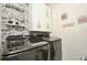 Modern laundry room with Samsung washer and dryer, stylish tile backsplash, and ample storage at 233 Tiffany Ct, Kissimmee, FL 34758