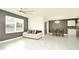 Living area with light beige couch, dark gray accent wall and tile floors at 233 Tiffany Ct, Kissimmee, FL 34758