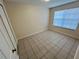 Bright bedroom with tile floors and two windows at 2332 Prime Cir # B, Kissimmee, FL 34746