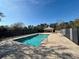 Community pool with a fenced-in area and shaded seating at 2332 Prime Cir # B, Kissimmee, FL 34746